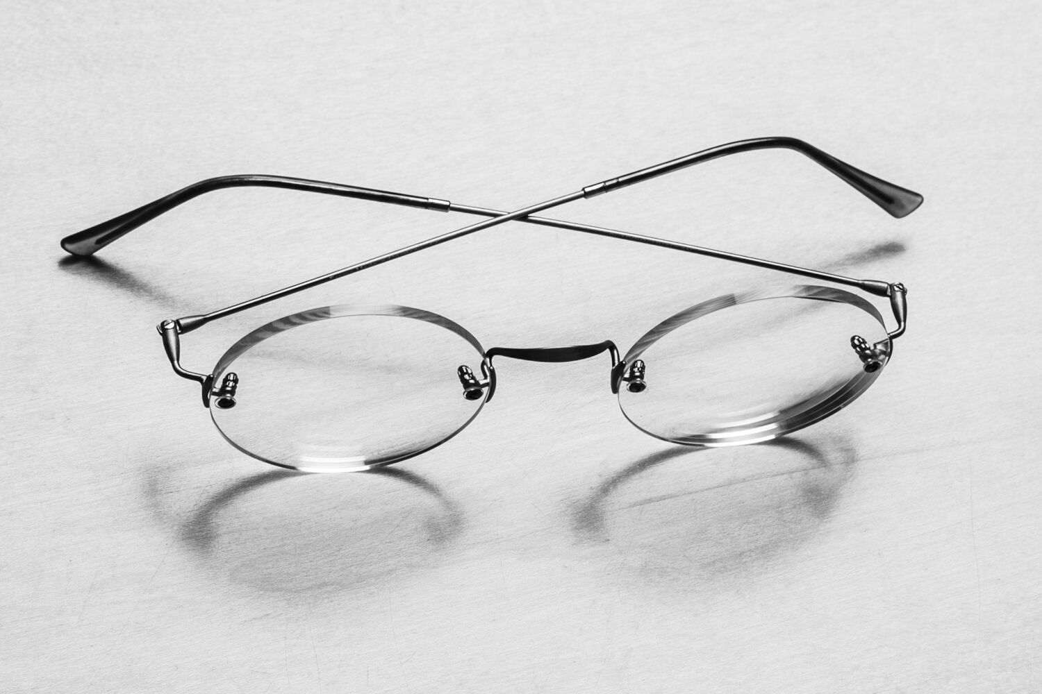 A pair of round-rimmed glasses belonging to Steve sit on a table.