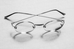 A pair of round-rimmed glasses belonging to Steve sit on a table.