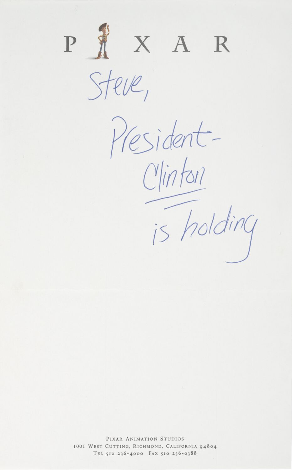 A note on Pixar letterhead. The handwritten text reads: Steve, President Clinton is holding.