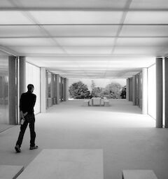 Dressed in dark colors, Steve walks away from the camera through a full-scale mockup of a corridor at Apple Park.