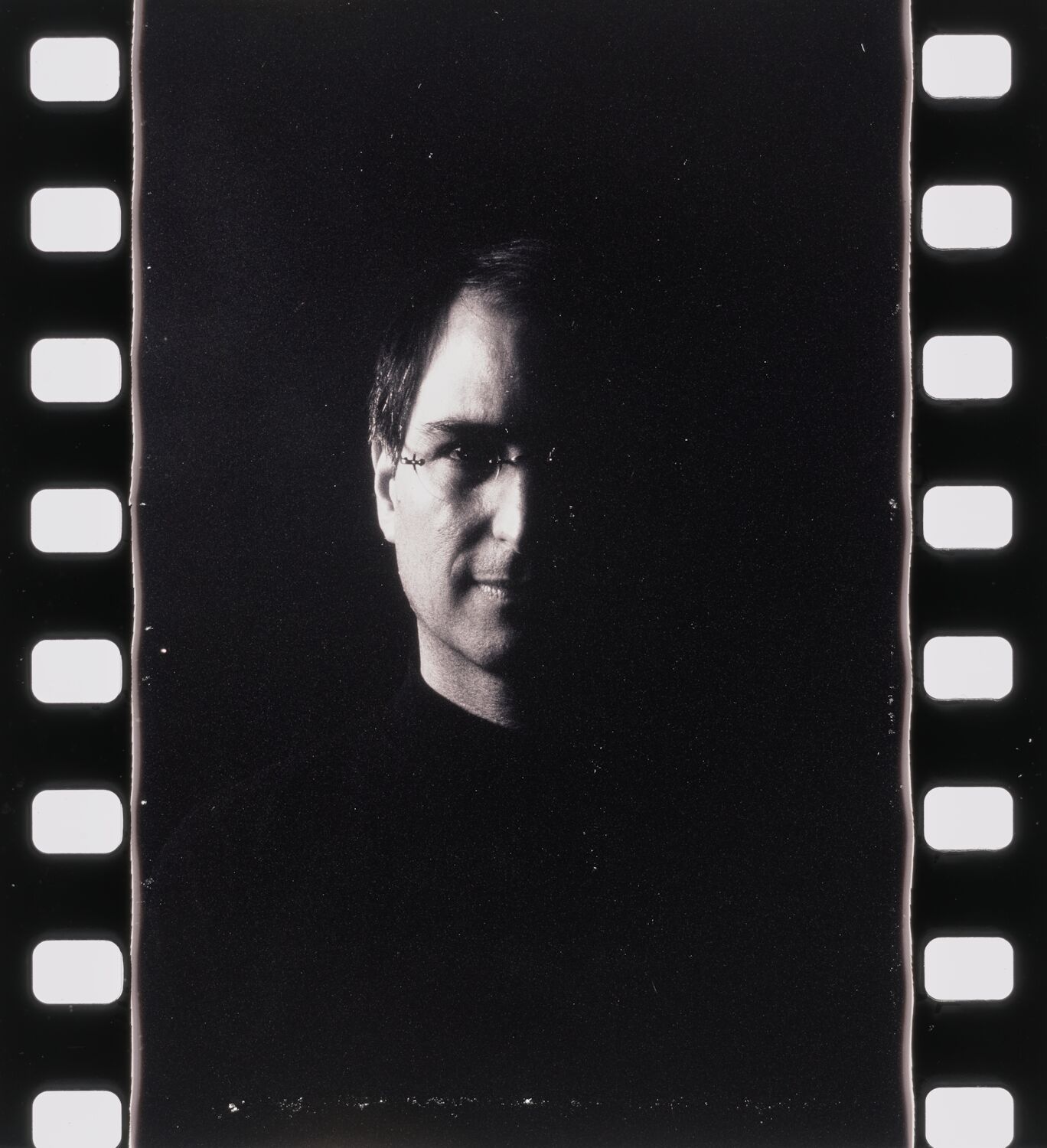 A photograph from a reel shows Steve in portrait. Only the left side of his face is visible; the rest is in deep shadow.