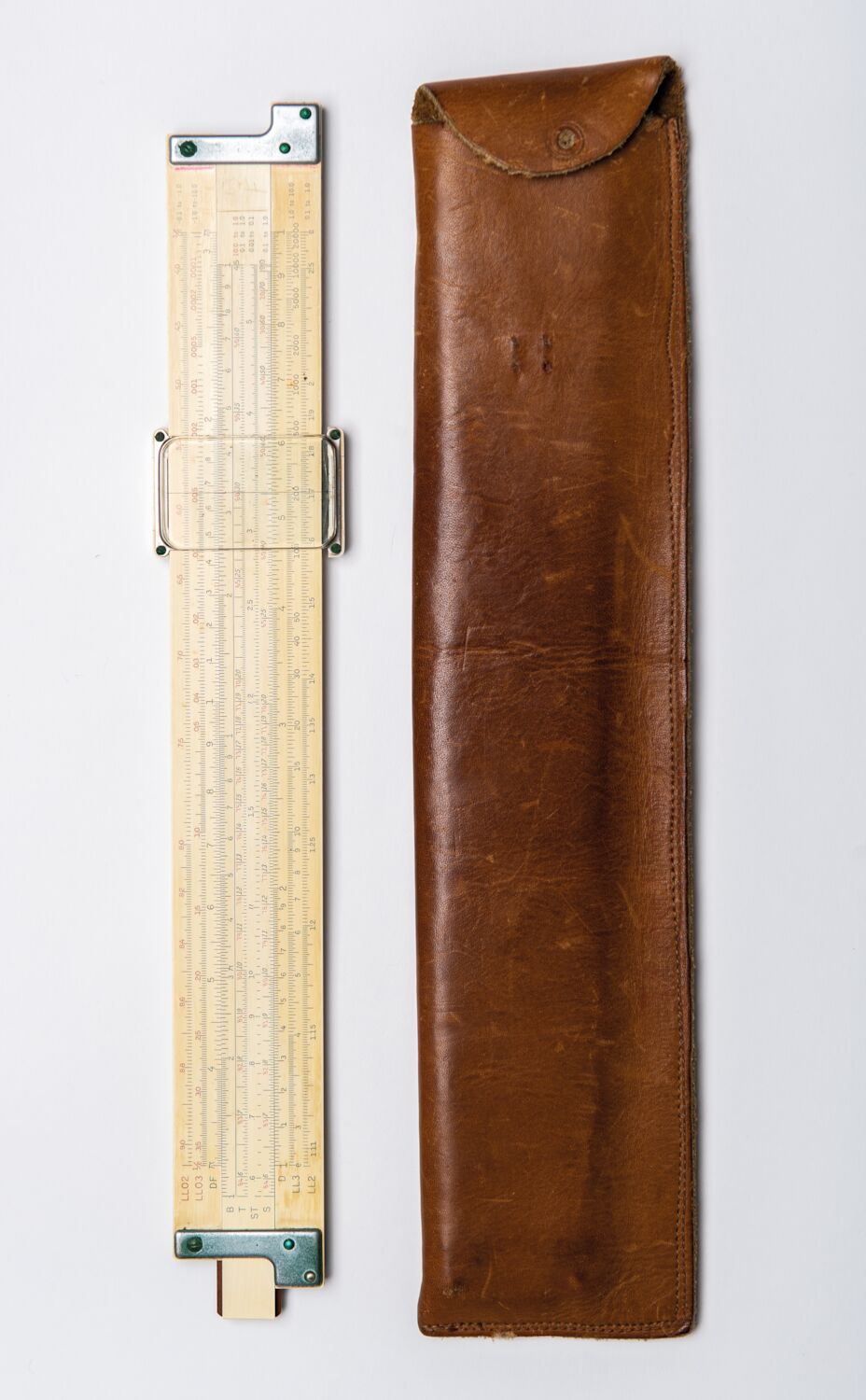 Steve’s vintage slide rule sits next to its brown leather case.