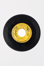 An autographed 45 of Great Balls of Fire by Jerry Lee Lewis, with bright yellow Sun records label.