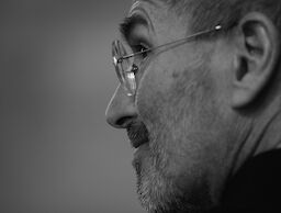 Steve shown in profile with stubbly beard and glasses. The photo is taken over his shoulder.